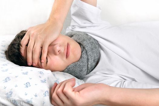 Sick Young Man lying on the Bed and feels Headache