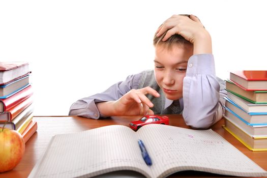 Bored Kid plays with a Toy on the School Desk on the white background