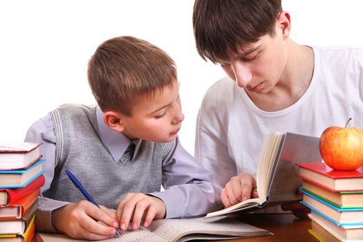 Older Brother helps Little Brother with a homework on the white background