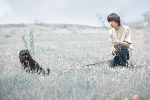 Young man with miniature Schnauzer
