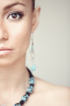 Woman with blue jewelry. Vertical photo