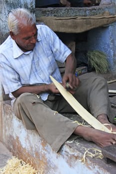 Indian man working with wood in the street, Bundi, Rajasthan, India