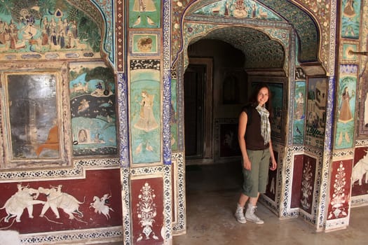 Young woman standing in Chitrashala hall, Bundi Palace, Rajasthan, India