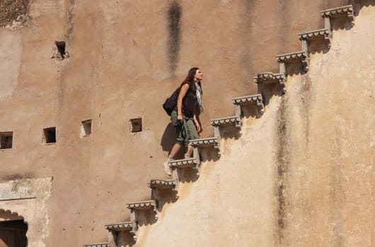 Young woman running up the stairs, Bundi Palace, Rajasthan, India