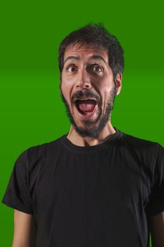 Young crazy man. Isolated over green background