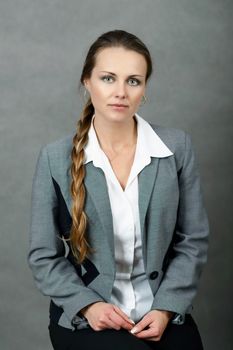 Portrait of middle age business woman on grey background with shallow focus