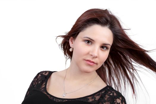 Fashion portrait of beautiful teenager girl with perfect skin and wind in hair on white background