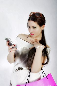 portrait of attractive fashion model looking at her cell phone
