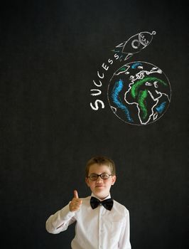 Thumbs up boy dressed up as business man with chalk globe and jet world travel on blackboard background