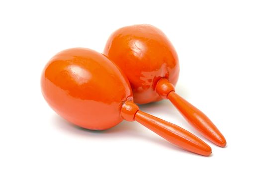 Orange maracas on white background