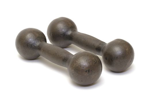 Old rusty iron dumbbells on white background