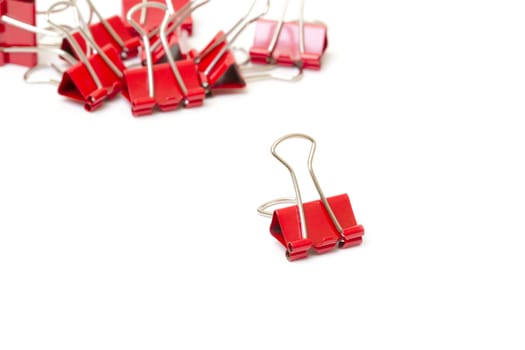 Red paper clips closeup on white