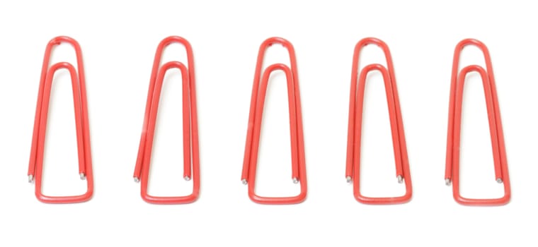 Red paper clips closeup on white