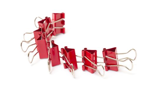 Chain of red paper clips closeup on white