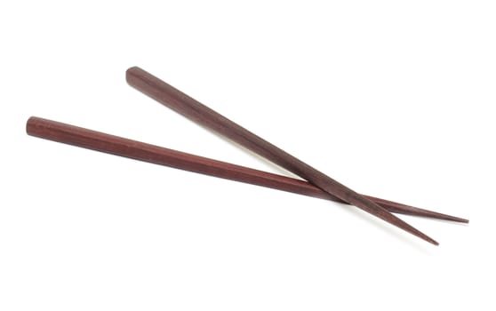 Dark wooden chopsticks on white background