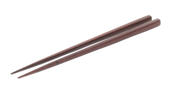 Dark wooden chopsticks on white background