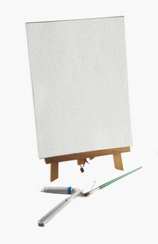 Blank canvas and instruments for painter over white background