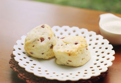 Homemade freshly baked scones with cream, retro filter effect