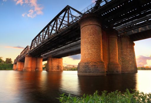 The Victoria Bridge Penrith, view from waters edge at sunset.  This is the old wrought iron and box plate girder bridge that crosses the Nepean River