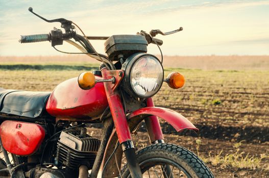 Classic old motorcycle on a dirt road. 