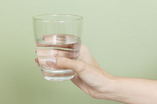 Woman hand with glass of water