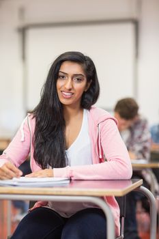 Portrait of a smiling young female student in the classroom
