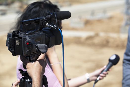 A journalist is making a interview with a microphone