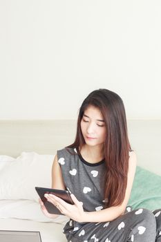 Young woman playing internet on tablet