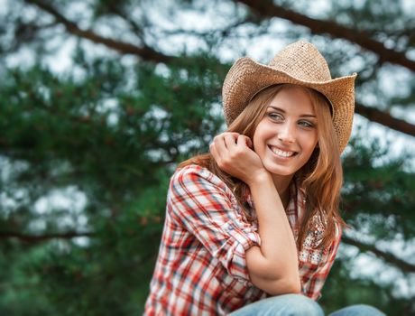 Sexy cowgirl. Young woman portrait in a hat