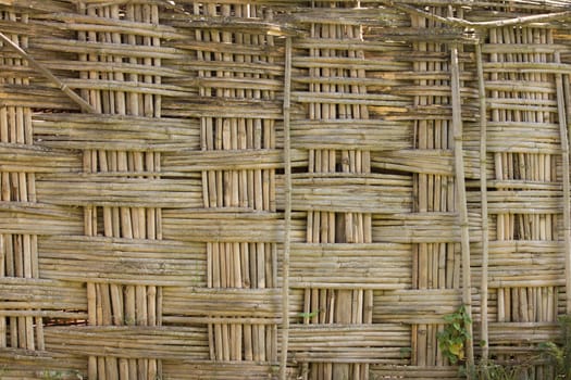 a fence made of bamboo in an African village