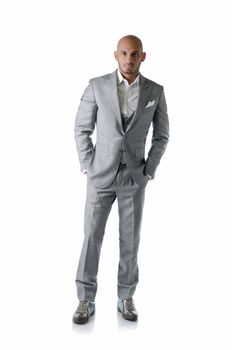 Full body shot of elegant, bald young man in business suit on white background, looking at camera