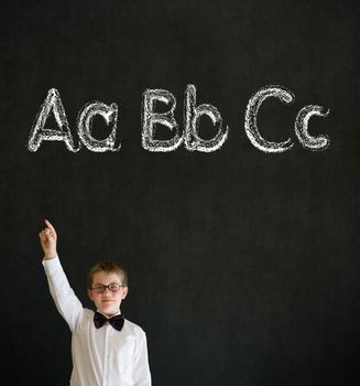 Hand up answer boy dressed up as business man with learn English language alphabet on blackboard background