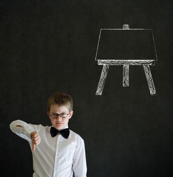 Thumbs down boy dressed up as business man with learn art chalk easel on blackboard background
