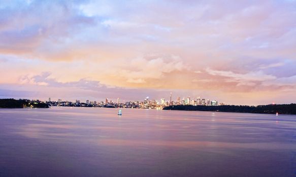 heavy storm clouds begin to break up over Sydney Harbour and City at Dawn