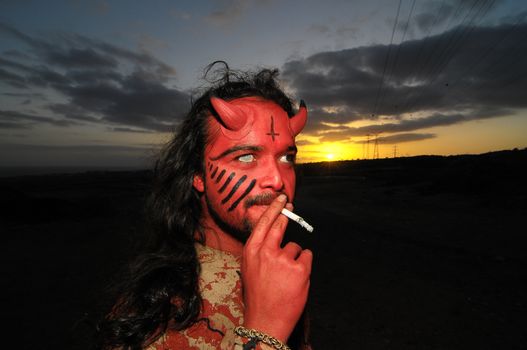 Latin American Man with Long Hairs Masked as a Devil in the Desert