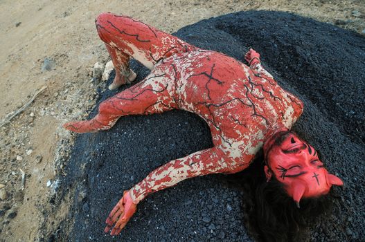 Latin American Man with Long Hairs Masked as a Devil in the Desert