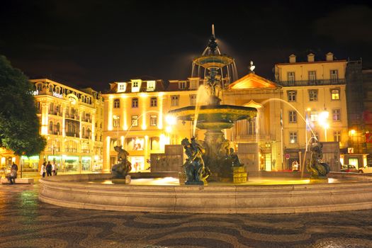 Night-lit fountain in Rossio Square, Lisbon, Portugal