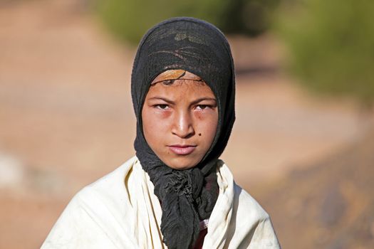 SAHARA DESERT, MOROCCO 19 OCTOBER 2013: Young nomad woman in the Sahara desert, Morocco. Nomadic tribes living in the desert, and a traditional lifestyle as a hundred years ago.