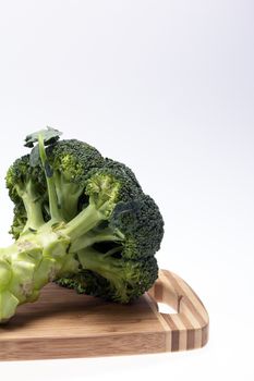 fresh broccoli on the cutting board on white background