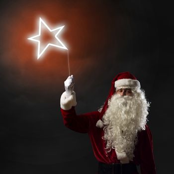 Santa Claus holding a shining light symbol of the star for thread