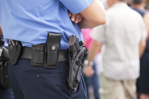 Police officer with handgun on his holster