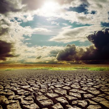 hot sun over drought earth with cracks