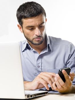 Young Man with Beard Working on Laptop and cellphone isolated on a White Background