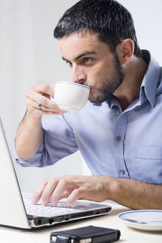 Young Man with Beard Working on Laptop isolated on a White Background