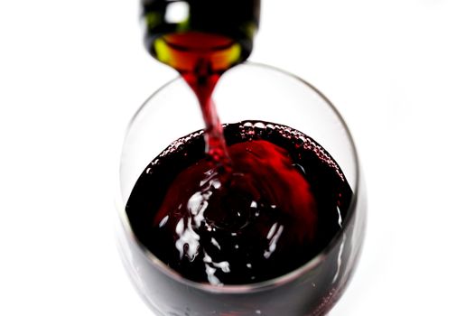 Bottle Neck close up filling Glass of Red Wine isolated white background