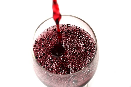 Red Wine stream poured on Glass isolated on white background