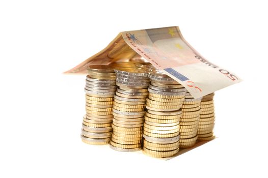 Euro Coins pile House with banknote roof  isolated on white background