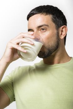 Young Handsome Man with Beard drinking Milk isolated on White Background