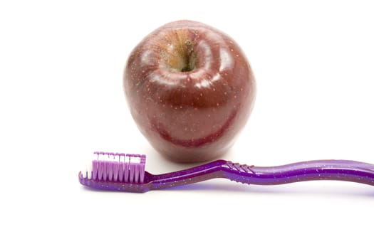 Fresh Red Apple with Toothbrush
