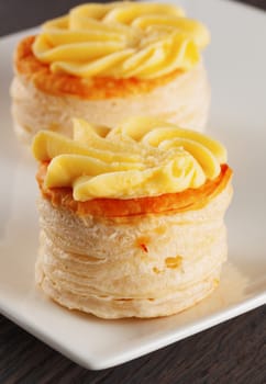 Appetizers, couple with cheese over a white plate, close up, vertical